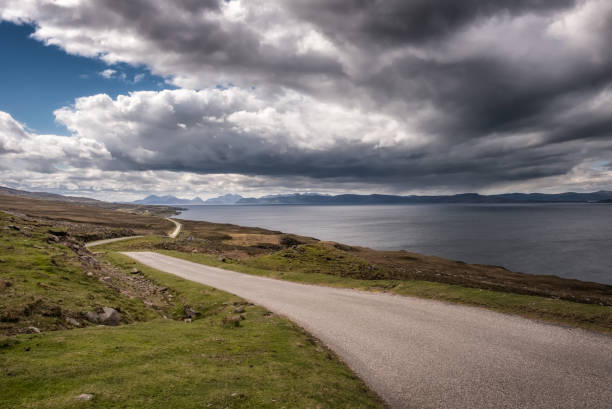 View across Inner Sound towards Skye in Scotland Deserted single lane road near Cuaig on the Applecross peninsula on the north west coast of Scotland with views over Inner Sound towards the Isle of Skye and other islands applecross peninsula stock pictures, royalty-free photos & images