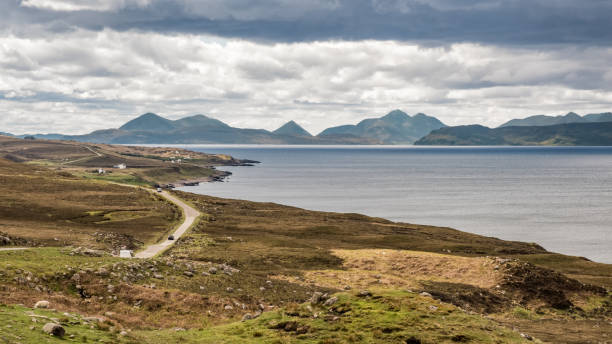View across Inner Sound towards Skye in Scotland Single lane road near Cuaig on the Applecross peninsula on the north west coast of Scotland with views over Inner Sound towards the Isle of Skye and other islands applecross peninsula stock pictures, royalty-free photos & images