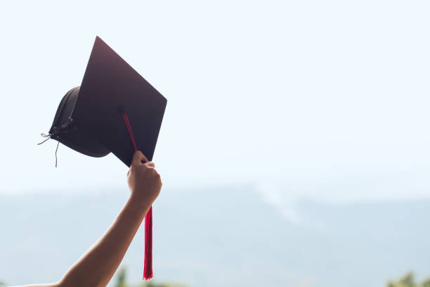 istock Graduation day,raising hands with graduation cap on sky.Commencement day, Congratulation 1167303485