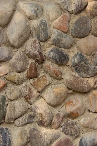 istock Old brown and gray cobblestone wall texture 1167304609