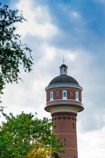 istock water tower and trees in Kevelaer, Germany. Cloudy sky, space for text 1167306576