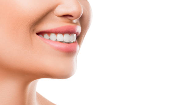 Close up photo of a woman smiling. Teeth whitening and health concept stock photo