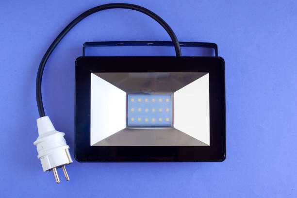 istock LED spotlight for street lighting, electric lamp on a blue background 1167307453