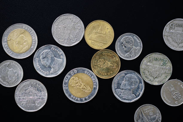 istock Thai Baht coins scattered on a dark background close-up 1167308924
