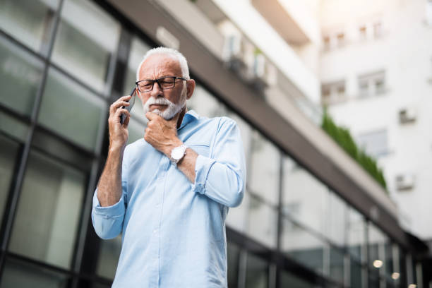 istock Serious senior man talking on a phone and contemplating. 1167309071
