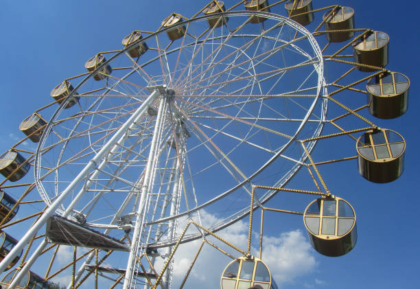 istock Large ferris wheel with cabins on a summer day against the blue sky 1167309164