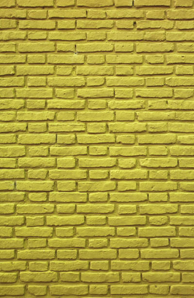istock Vertical Image of Mustard Yellow Colored Brick Wall for Background, Pattern and Texture 1167314903