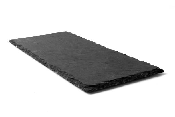 istock Black stone plate isolated on white background 1167316070