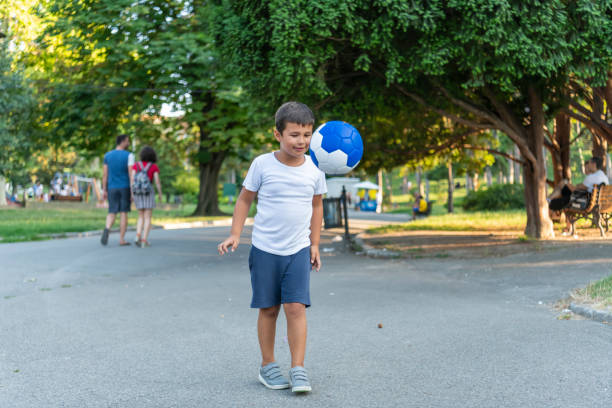 istock Boy play with football ball 1167321457