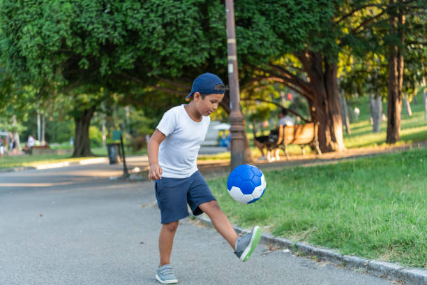 istock Boy play with football ball 1167321499