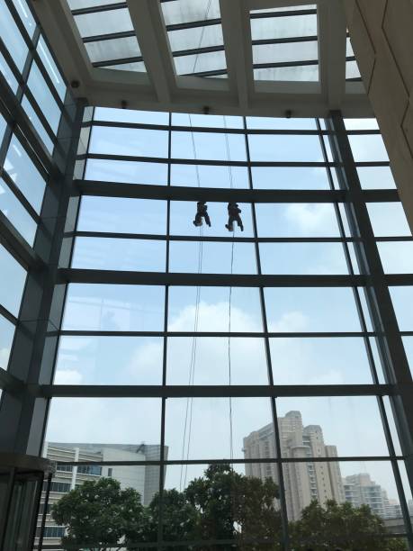 istock Building glass cleaner hanging from the top 1167321687