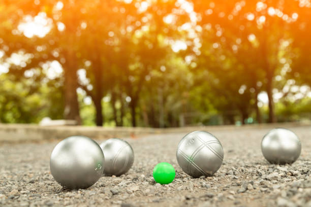 Close up of several different colored colorful plastic balls with small ball for bocce game on white background