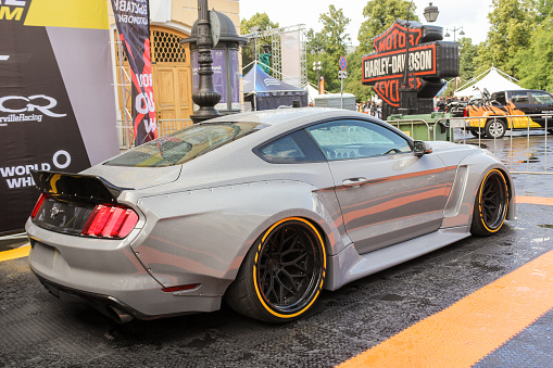 St. Petersburg, Russia - 3 August, 2019.\nThe annual festival of bikers in St. Petersburg Harley Davidson.\nSports car Ford Mustang.