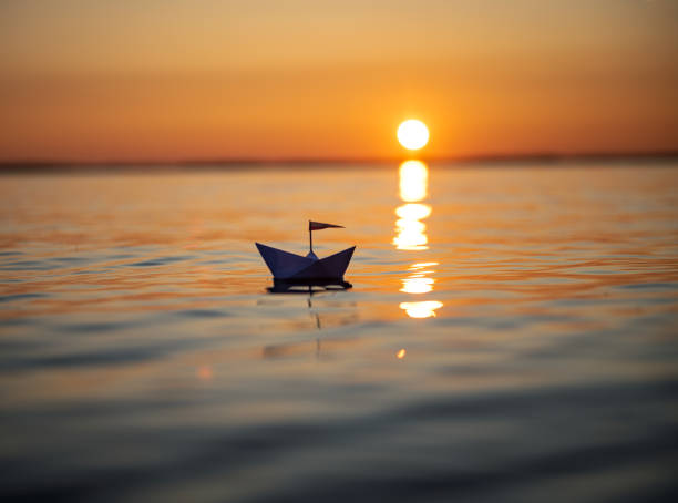istock Paper Boat at Sunset Lake 1167324641