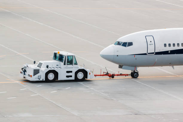 istock airplane on airport runway with pushback tractor. 1167325435