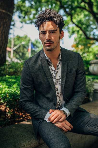 istock Handsome man sitting in park 1167325628