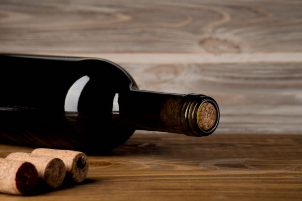 istock Bottle of wine with corkscrew on wooden background 1167326621