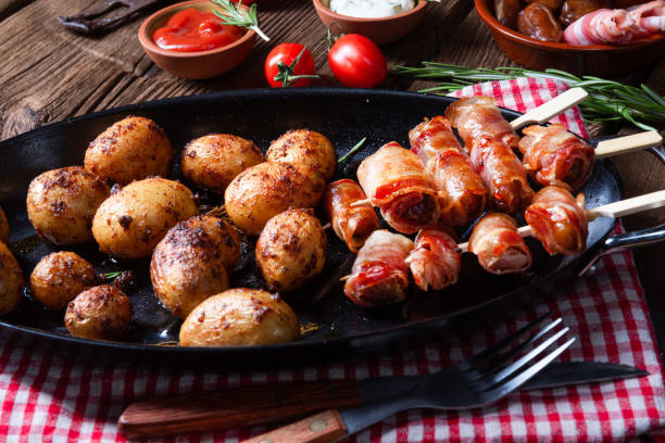 istock Rustic dates wrapped in bacon and young roasted potato. 1167326751