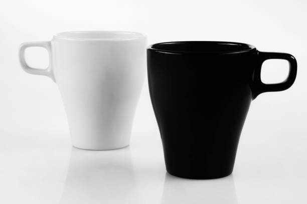istock White mug and black mug on a white background 1167327532