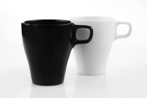 istock White mug and black mug on a white background 1167327539