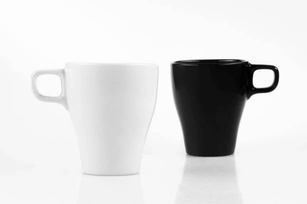 istock White mug and black mug on a white background 1167327549
