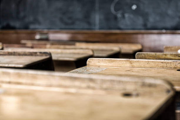 istock Student Antique Wood Desks in Old School Classroom 1167327660