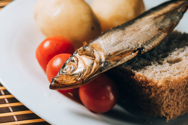 istock smoked sprat fish on bread home-style white plate 1167328807