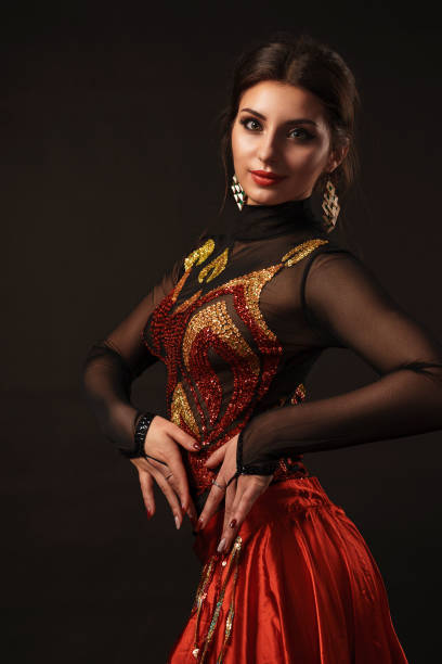 istock Beautiful belly dancer perfoming exotic dance in red flutter dress 1167330986