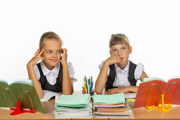 istock Two girls thought about an abstract topic while sitting at a desk at school 1167332443