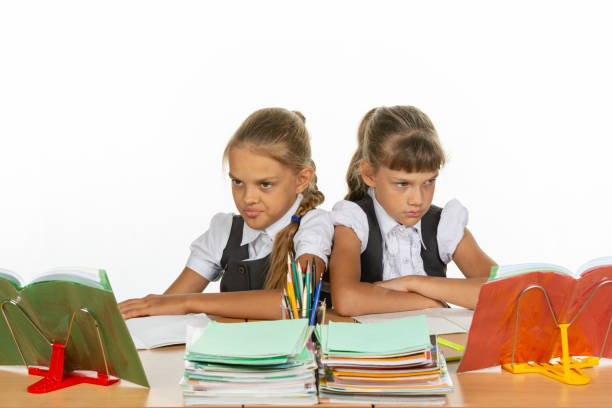 istock Two quarreling girls at the same desk 1167332444