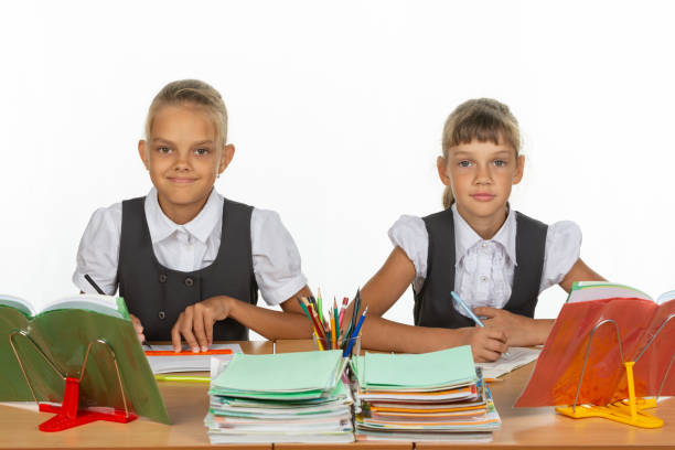 istock Two schoolgirls gaze intently and emotionlessly into the frame 1167332450