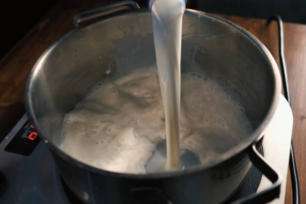 istock Pouring milk into the pan on scales. 1167332845