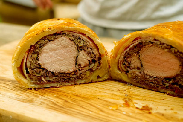 istock a Prepared meatloaf with dough roll cutting meatloaf. 1167332850