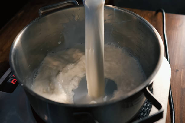 istock Pouring milk into the pan on scales. 1167332851