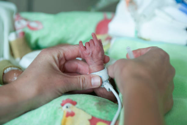 istock Premature baby holds mothers hand 1167335114