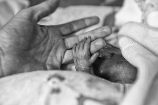 istock Premature baby holds mothers hand 1167335288