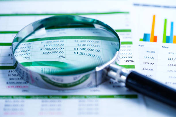istock Magnifying glass on charts graphs spreadsheet paper. Financial development, Banking Account, Statistics, Investment Analytic research data economy, Stock exchange trading, Business office company meeting concept. 1167337263