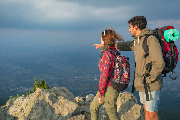 istock Couple hikers standing on the mountain peak 1167338043