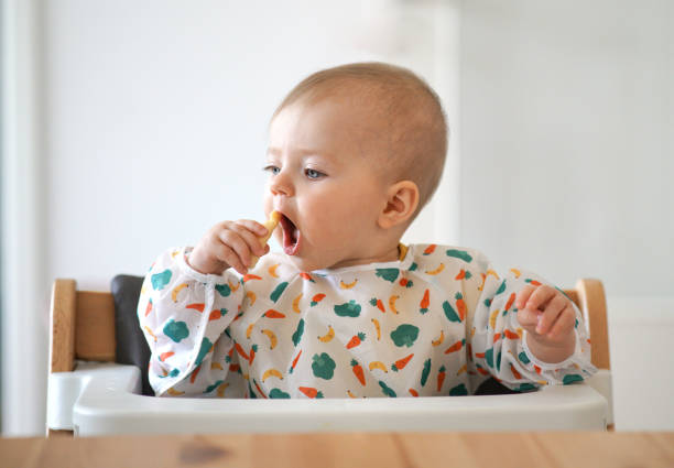 istock Little baby eating her snack herself 1167340466