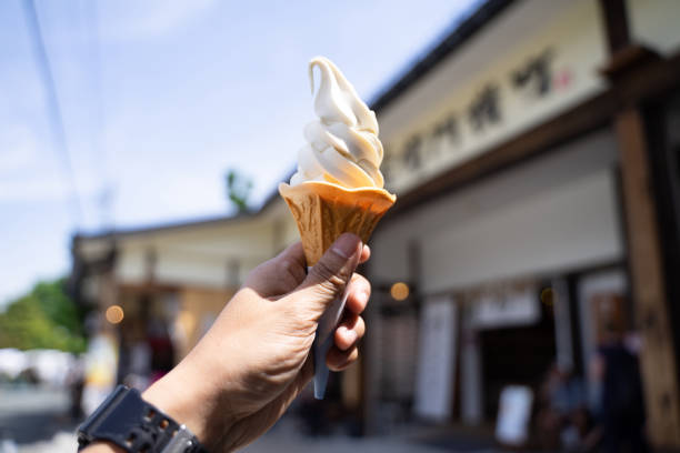 istock Ice cream in the hand held up in the sky 1167342376