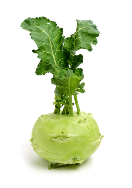 istock Fresh kohlrabi with green leaves on isolated white backround 1167342476