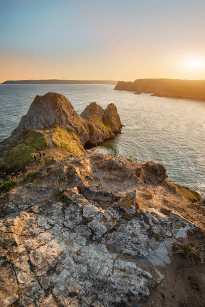 istock Beautiful peaceful Summer evening sunset beach landscape image at Three Cliffs Bay in South Wales 1167343142