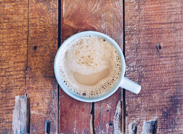 istock A cup of coffee in a white cup on wooden background 1167343419