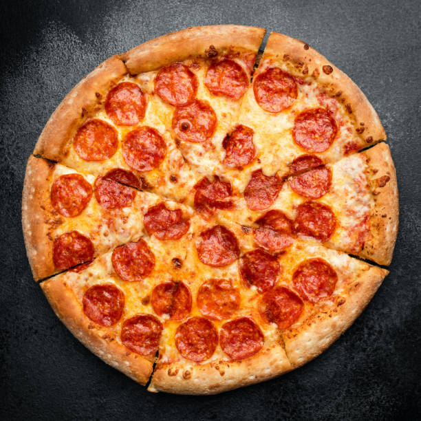 istock Tasty Pepperono Pizza On Black Concrete Background 1167344015
