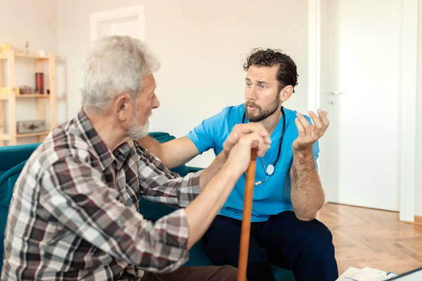 istock Male Caretaker Talking to Elder Man Patient 1167344205