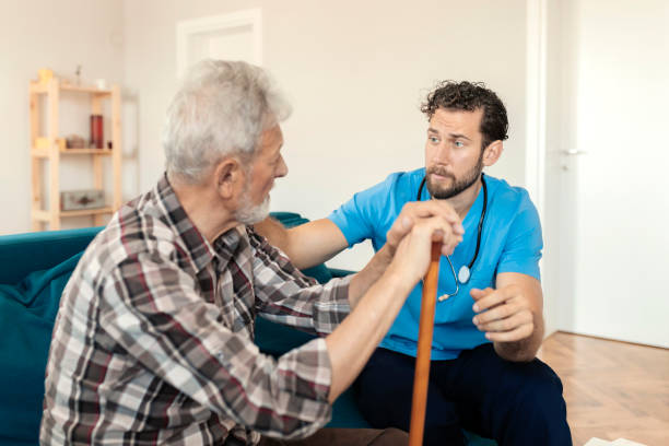 istock Male Caretaker Talking to Elder Man Patient 1167344244