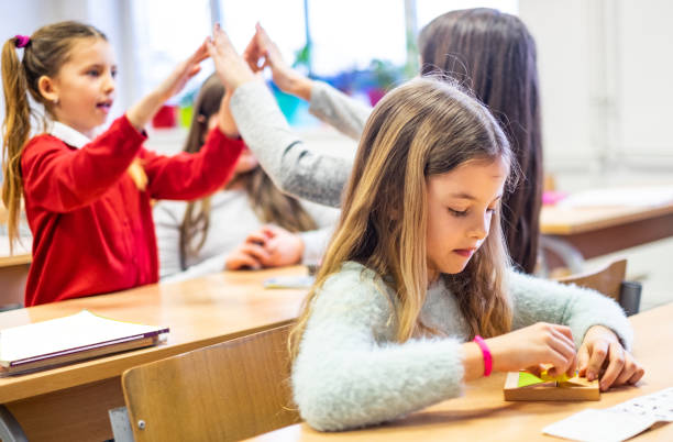 istock Schoolgirls enjoying in classroom 1167345370