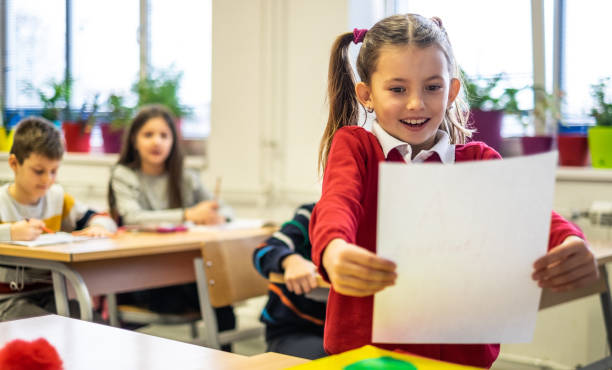 istock Happy schoolgirl because get a high grade 1167345394
