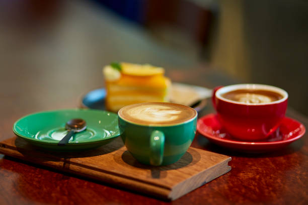 Selective focus of colorful cup of coffee on wooden table