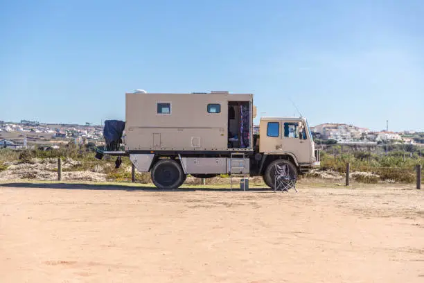 Photo of An adventure camper truck situated at the beach